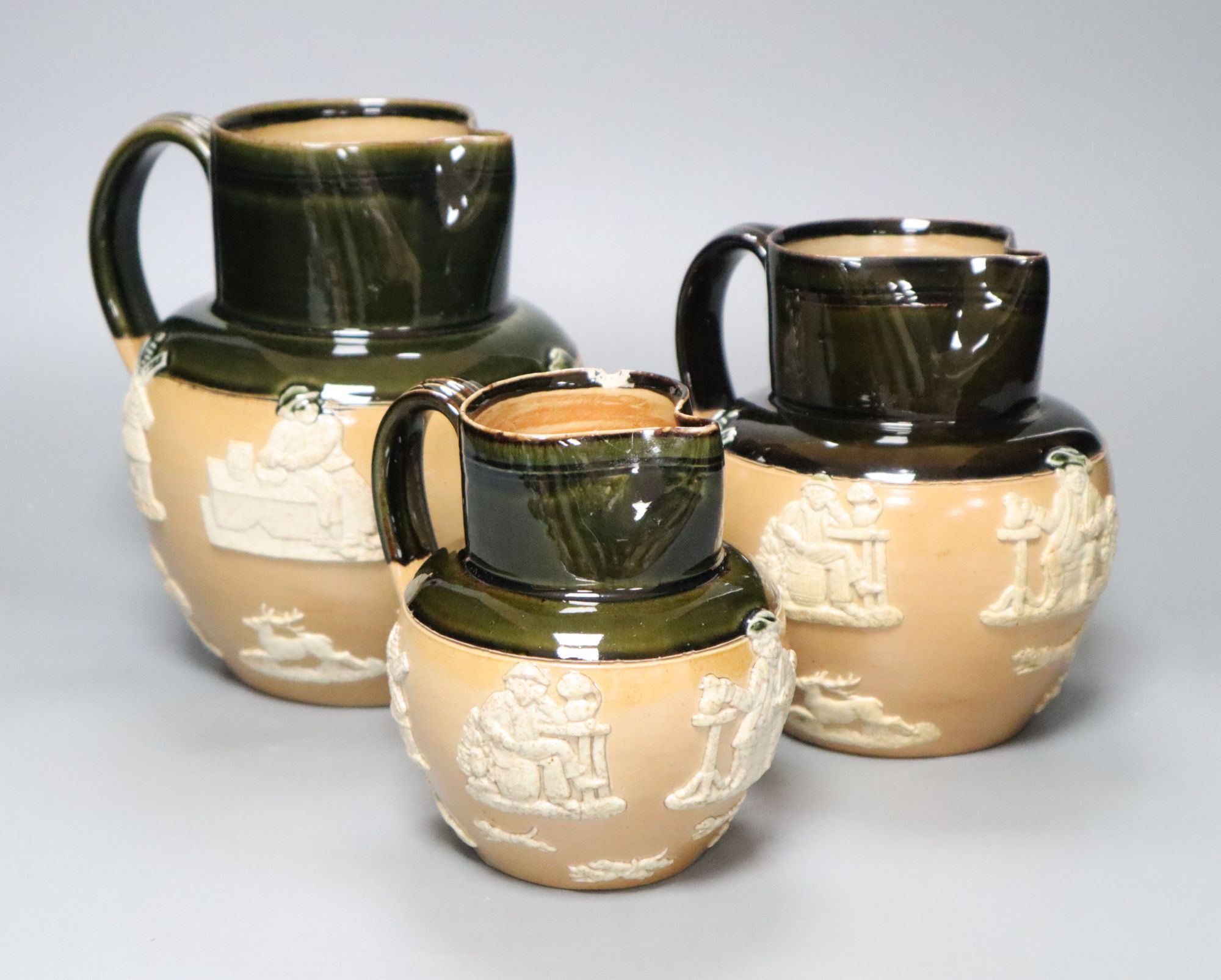 A graduated set of three Victorian Royal Doulton earthenware harvest jugs, tallest 19cm